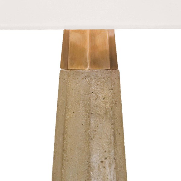 The natural brass fitting of a concrete table lamp